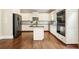 Spacious kitchen with white cabinets, stainless steel appliances, and a granite-topped island at 603 Redcoat Cir, Canton, GA 30114