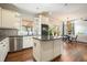 Bright kitchen includes a central island, stainless appliances, and an adjacent dining area at 603 Redcoat Cir, Canton, GA 30114