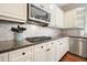 Close-up of kitchen showcasing granite countertops, stainless steel appliances, and custom backsplash at 603 Redcoat Cir, Canton, GA 30114