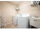 Well-lit laundry room with modern appliances and tile flooring at 603 Redcoat Cir, Canton, GA 30114