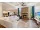 Open-concept living room with a stone fireplace, coffered ceiling, and hardwood floors at 603 Redcoat Cir, Canton, GA 30114