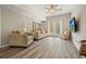 Inviting living room with plush seating, neutral tones, and a French door at 603 Redcoat Cir, Canton, GA 30114
