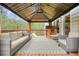Covered deck featuring comfortable seating, stylish rug, and outdoor playhouse at 603 Redcoat Cir, Canton, GA 30114
