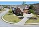 Beautiful brick home from an aerial view showcasing the roof, landscaping, and driveway at 866 Coopers Ridge Sw Path, Grayson, GA 30017