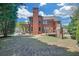 Spacious backyard, showcasing the home's brick exterior, mature trees, and inviting outdoor spaces for relaxation and entertainment at 866 Coopers Ridge Sw Path, Grayson, GA 30017