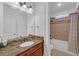 Bright bathroom featuring granite countertops and a shower-tub combination at 866 Coopers Ridge Sw Path, Grayson, GA 30017