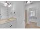 Well-lit bathroom with white cabinetry and built-in shower bench at 866 Coopers Ridge Sw Path, Grayson, GA 30017