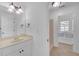 Clean bathroom with tiled floors, vanity, a tub with window view, and modern fixtures at 866 Coopers Ridge Sw Path, Grayson, GA 30017
