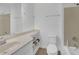 Bright bathroom with a single sink vanity, tiled floor, and a shower with glass door and chrome fixtures at 866 Coopers Ridge Sw Path, Grayson, GA 30017