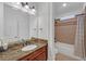 Elegant bathroom featuring a marble countertop, dark wood cabinetry and tiled shower and bath at 866 Coopers Ridge Sw Path, Grayson, GA 30017