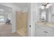 Bathroom featuring a shower, sink, and view into a bedroom at 866 Coopers Ridge Sw Path, Grayson, GA 30017