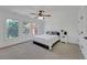 Well-lit bedroom featuring three windows, a ceiling fan, and neutral decor for a calm atmosphere at 866 Coopers Ridge Sw Path, Grayson, GA 30017