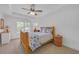 Inviting bedroom featuring a wooden bed frame, plush carpet and natural light at 866 Coopers Ridge Sw Path, Grayson, GA 30017