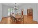 Bright dining room features a chandelier, hardwood floors, and large windows that let in natural light at 866 Coopers Ridge Sw Path, Grayson, GA 30017