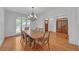 Elegant dining room featuring hardwood floors, large windows, and a stylish chandelier at 866 Coopers Ridge Sw Path, Grayson, GA 30017