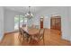 Bright dining room with hardwood floors, large windows, and classic chandelier lighting at 866 Coopers Ridge Sw Path, Grayson, GA 30017
