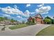 View of the home from the driveway, with brick facade, manicured lawn, and mature landscaping at 866 Coopers Ridge Sw Path, Grayson, GA 30017