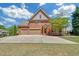 Brick home with a two-car garage, well-manicured lawn, and mature tree at 866 Coopers Ridge Sw Path, Grayson, GA 30017