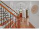 Beautiful foyer with hardwood floors, staircase with iron spindles, and elegant lighting fixture at 866 Coopers Ridge Sw Path, Grayson, GA 30017