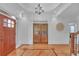 Elegant foyer with hardwood flooring, transom windows, and a view into the adjacent office and stairs at 866 Coopers Ridge Sw Path, Grayson, GA 30017