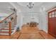 Grand foyer featuring hardwood floors, elegant staircase, and views into the dining area at 866 Coopers Ridge Sw Path, Grayson, GA 30017