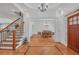 Elegant foyer with hardwood floors, staircase, and dining room view at 866 Coopers Ridge Sw Path, Grayson, GA 30017