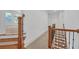 Hallway with staircase and carpet, leading to rooms with abundant natural light at 866 Coopers Ridge Sw Path, Grayson, GA 30017