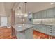 Charming kitchen featuring gray cabinets, stainless steel appliances, a tile backsplash, and a granite countertop island at 866 Coopers Ridge Sw Path, Grayson, GA 30017