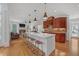 Modern kitchen features a large island, stainless steel appliances, hardwood floors, and seamless access to the living room at 866 Coopers Ridge Sw Path, Grayson, GA 30017