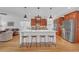 Well-lit kitchen features a large island with barstool seating, stainless steel appliances, and hardwood floors at 866 Coopers Ridge Sw Path, Grayson, GA 30017