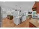 Expansive kitchen boasts a large island, stainless steel appliances, hardwood floors, and access to dual living areas at 866 Coopers Ridge Sw Path, Grayson, GA 30017