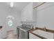 Well-lit laundry room with modern washer, dryer, sink, and cabinets at 866 Coopers Ridge Sw Path, Grayson, GA 30017