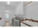 Well-lit laundry room with granite countertops, sink, cabinets, washer and dryer at 866 Coopers Ridge Sw Path, Grayson, GA 30017