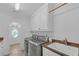 Modern laundry room with front load washer and dryer, cabinetry, sink, and countertops at 866 Coopers Ridge Sw Path, Grayson, GA 30017