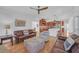 Open-concept living room featuring hardwood floors and seamless transition to the kitchen area at 866 Coopers Ridge Sw Path, Grayson, GA 30017