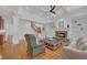 Open living room features hardwood floors, a fireplace, built-in bookshelves, and access to the kitchen at 866 Coopers Ridge Sw Path, Grayson, GA 30017