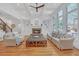 Bright living room features hardwood floors, a fireplace, large windows, and access to backyard living at 866 Coopers Ridge Sw Path, Grayson, GA 30017