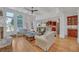 Open-concept living room boasts large windows, a ceiling fan, and hardwood floors, perfect for entertaining at 866 Coopers Ridge Sw Path, Grayson, GA 30017
