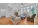 Cozy living room features built-in bookshelves, hardwood floors, a fireplace, and large windows with backyard views at 866 Coopers Ridge Sw Path, Grayson, GA 30017