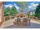 Deck with outdoor stone fireplace, dining table, and chair set, perfect for entertaining at 866 Coopers Ridge Sw Path, Grayson, GA 30017
