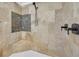 Modern shower featuring stone-look tile, a built-in bench, and a sleek, handheld shower head at 866 Coopers Ridge Sw Path, Grayson, GA 30017