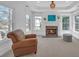 Sitting room with fireplace, large windows, tray ceilings and neutral paint colors at 866 Coopers Ridge Sw Path, Grayson, GA 30017