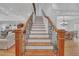 Grand staircase featuring wood and iron railings, bathed in natural light at 866 Coopers Ridge Sw Path, Grayson, GA 30017