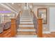 Elegant staircase with wooden steps, decorative railings, and basement access at 866 Coopers Ridge Sw Path, Grayson, GA 30017