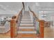 Elegant staircase with wooden steps, decorative iron railing, and white accents for a grand entryway at 866 Coopers Ridge Sw Path, Grayson, GA 30017
