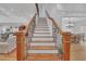Open staircase with wood railing and iron spindles leads to the second floor at 866 Coopers Ridge Sw Path, Grayson, GA 30017