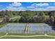 Aerial view of tennis courts in a residential community with lush trees and sky at 866 Coopers Ridge Sw Path, Grayson, GA 30017