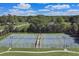Aerial view of tennis courts surrounded by lush greenery and residential buildings, providing recreational amenities at 866 Coopers Ridge Sw Path, Grayson, GA 30017