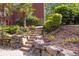 Beautiful backyard landscaping with stone steps and lush greenery leading to the house at 1459 Harris Rd, Lawrenceville, GA 30043