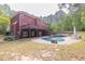 Sprawling backyard featuring a pool, covered patio, and lush landscaping, ideal for outdoor living and entertaining at 1459 Harris Rd, Lawrenceville, GA 30043